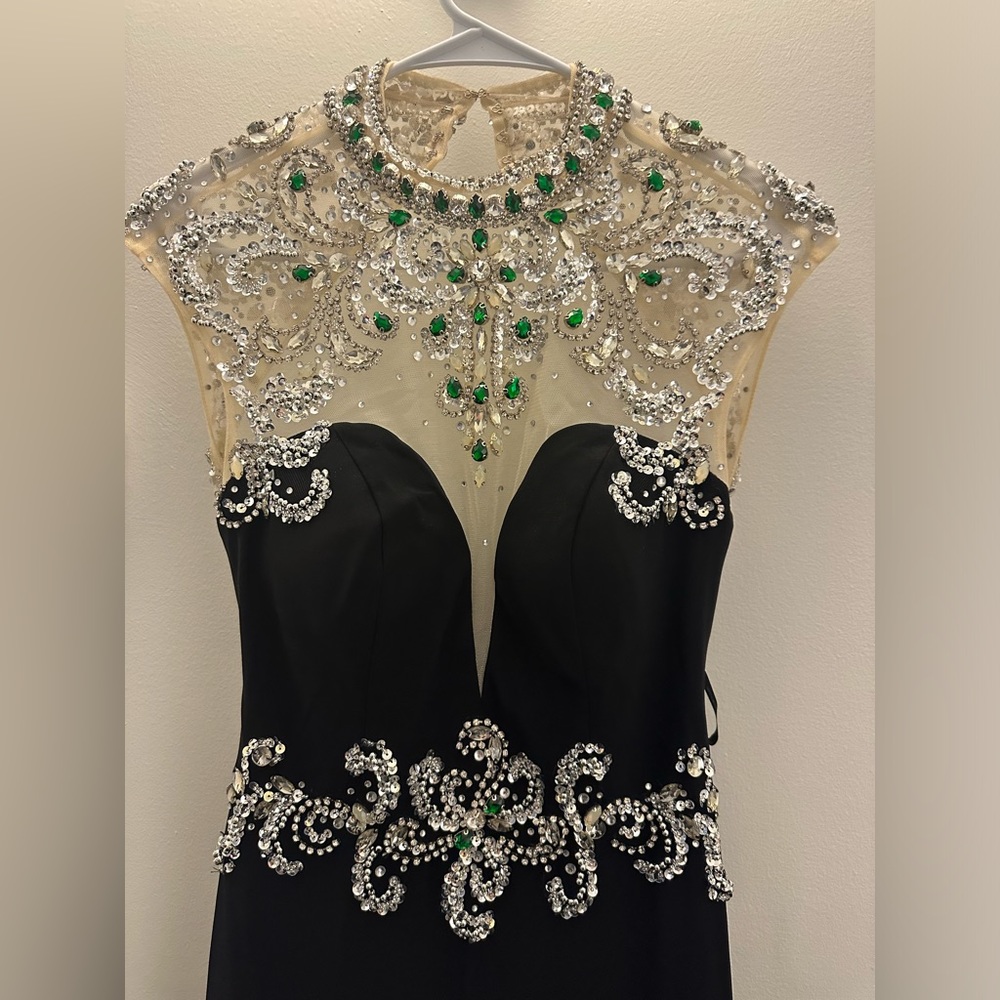 Selling a long black dress with short sleeve and green rhinestones!
